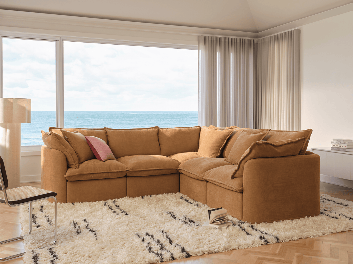 Koala Tamarama 5-section L-shape sectional in Bronzed Aussie, with terracotta velvet cushion and city view