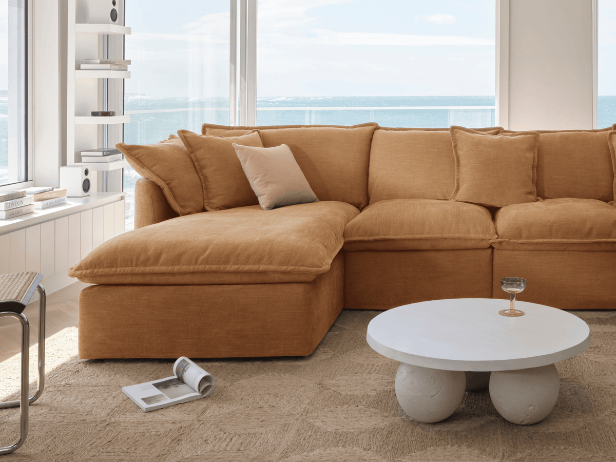 Koala Tamarama 6-section L-shape sectional with chaise in Bronzed Aussie, with monstera plant and Noguchi glass table
