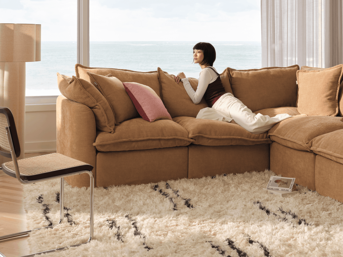 Koala Tamarama 6-section L-shape sectional with chaise in Bronzed Aussie, with two models reclining and terracotta cushion