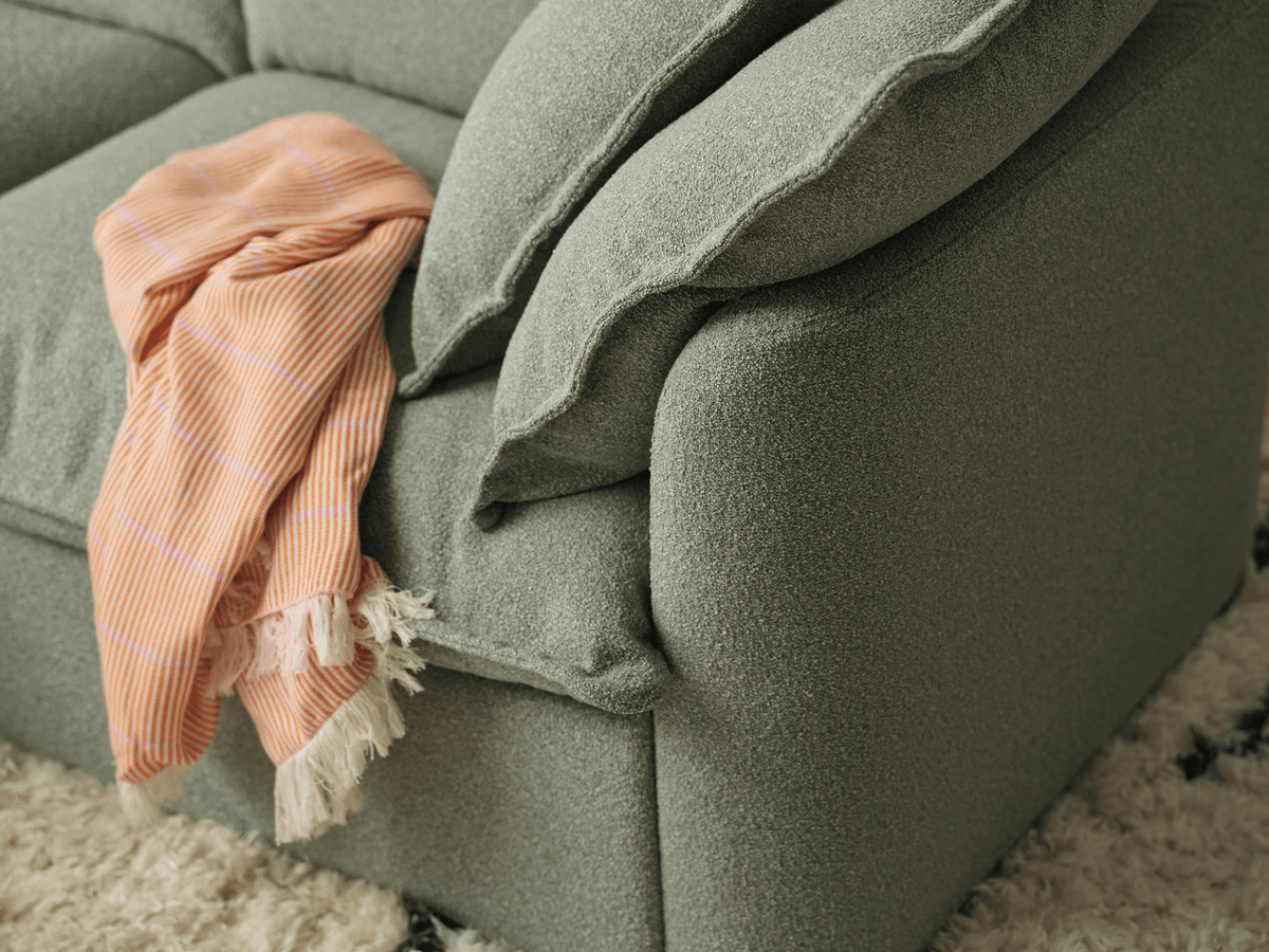 Koala Tamarama 4-section L-shape sectional in Frosty Grass, linen scatter cushions with sunlit art books