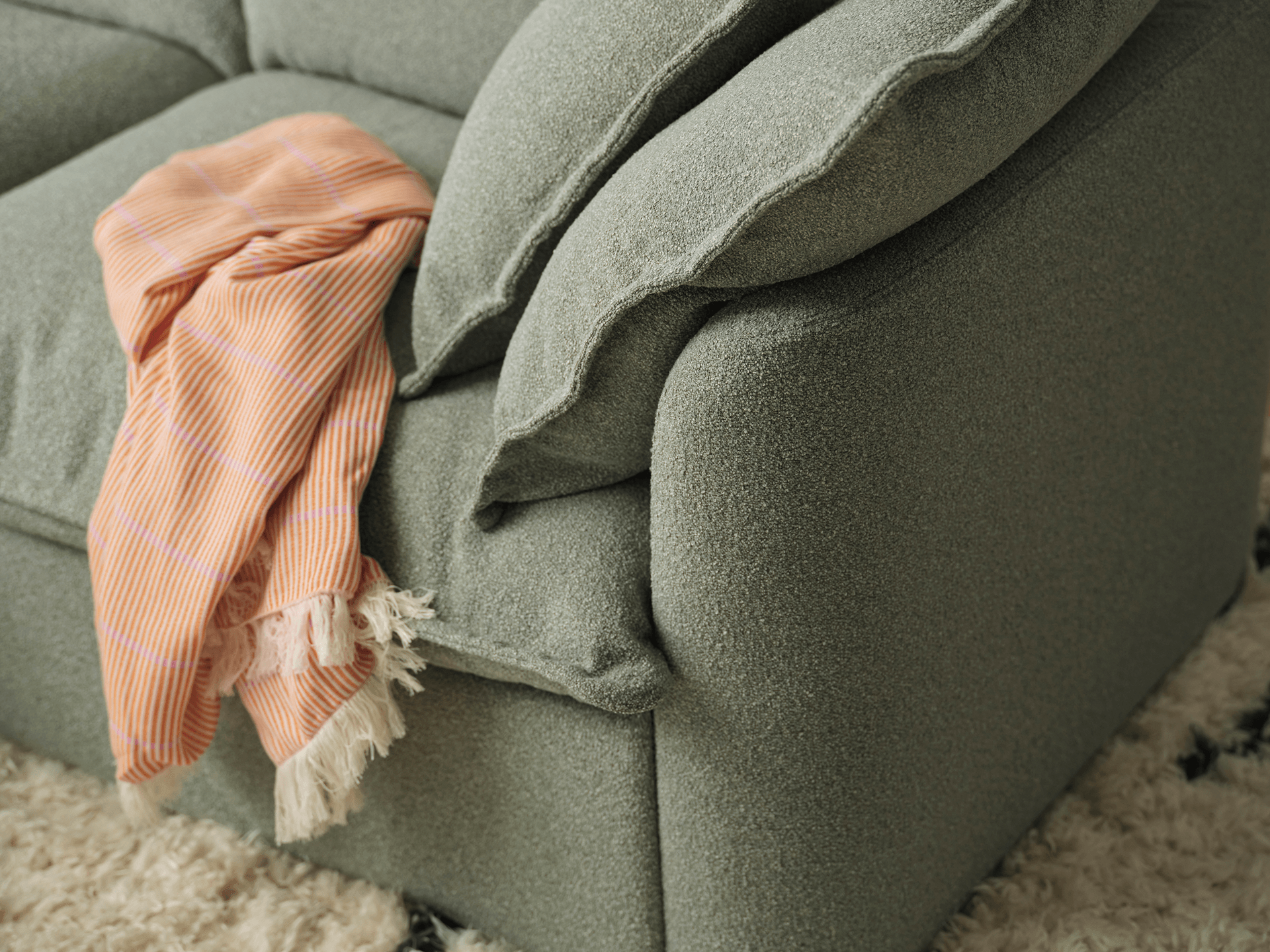Koala Tamarama 6-section U-shape sectional in Frosty Grass, corner detail with terracotta cushion and wavy lamp
