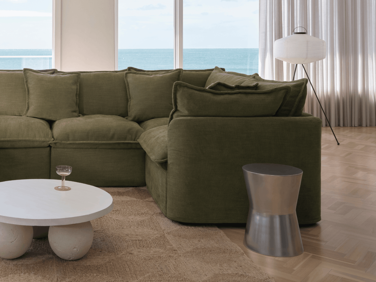Koala Tamarama 4-section L-shape sectional in Forest Walk, linen scatter cushions with sunlit art books