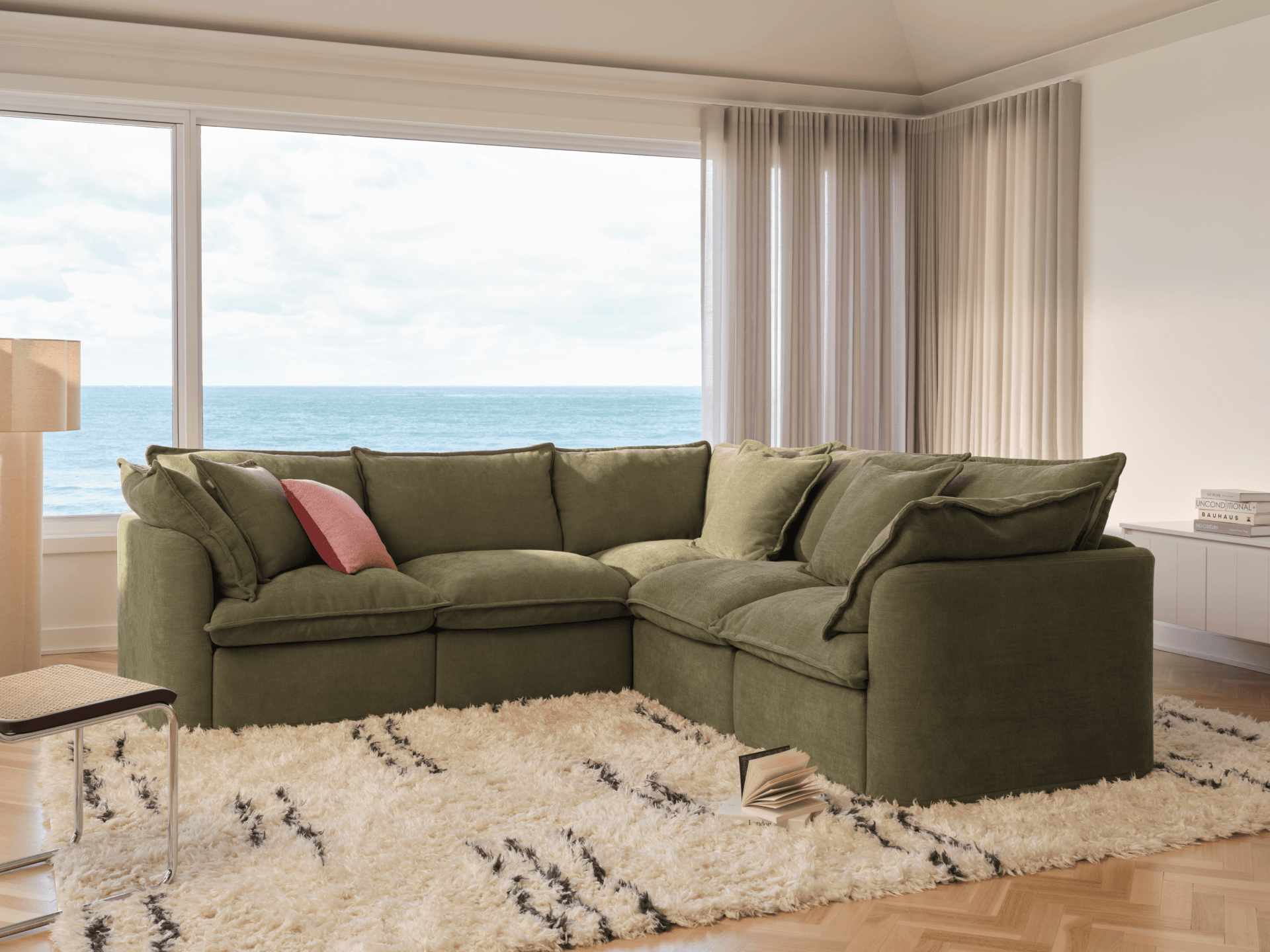 Koala Tamarama 5-section L-shape sectional in Forest Walk, with terracotta velvet cushion and city view