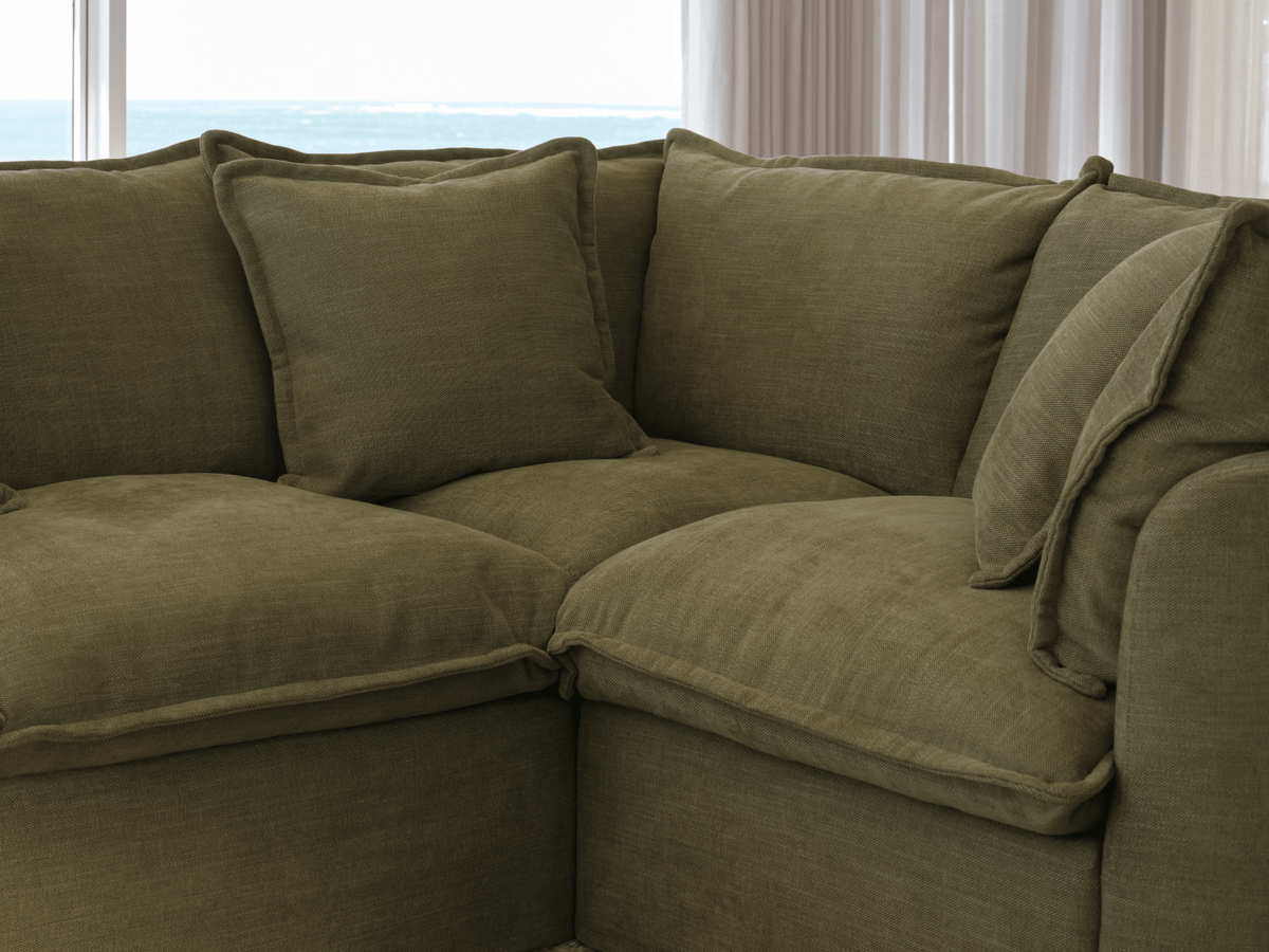 Koala Tamarama 5-section L-shape sectional in Forest Walk, with terracotta velvet cushion and city view