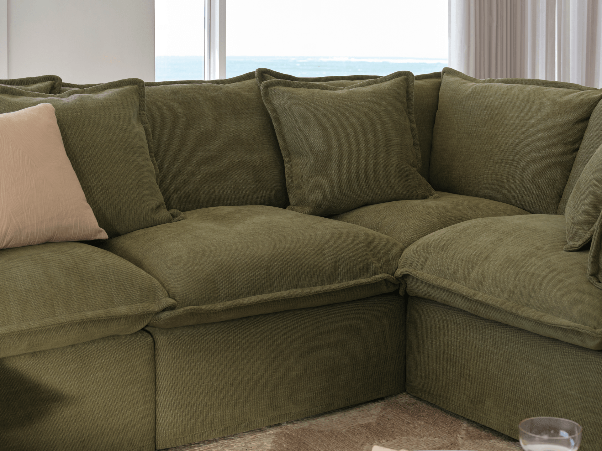 Koala Tamarama 6-section L-shape sectional in Forest Walk, with terracotta velvet cushion and city view