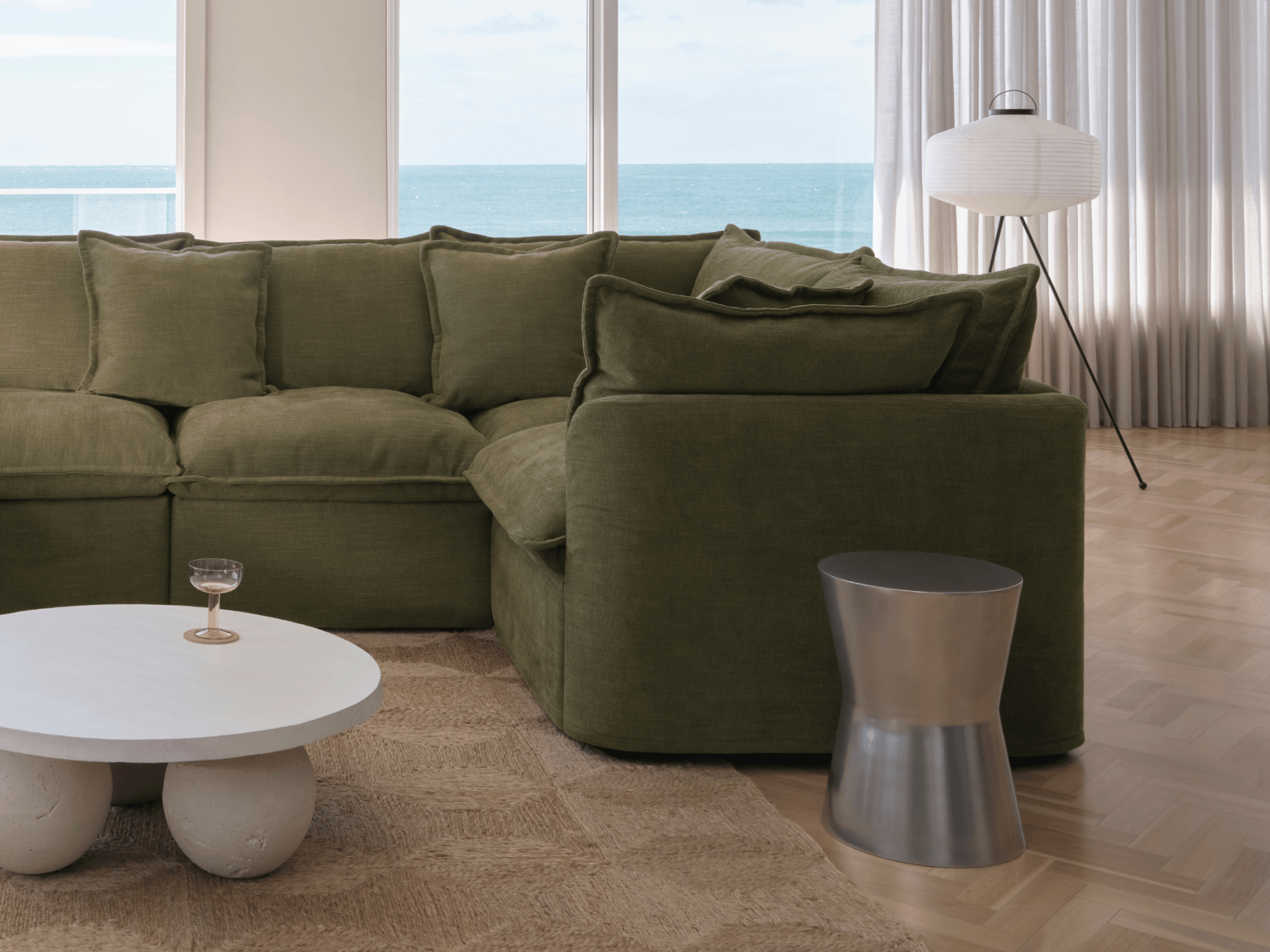 Koala Tamarama 6-section L-shape sectional in Forest Walk, linen scatter cushions with sunlit art books