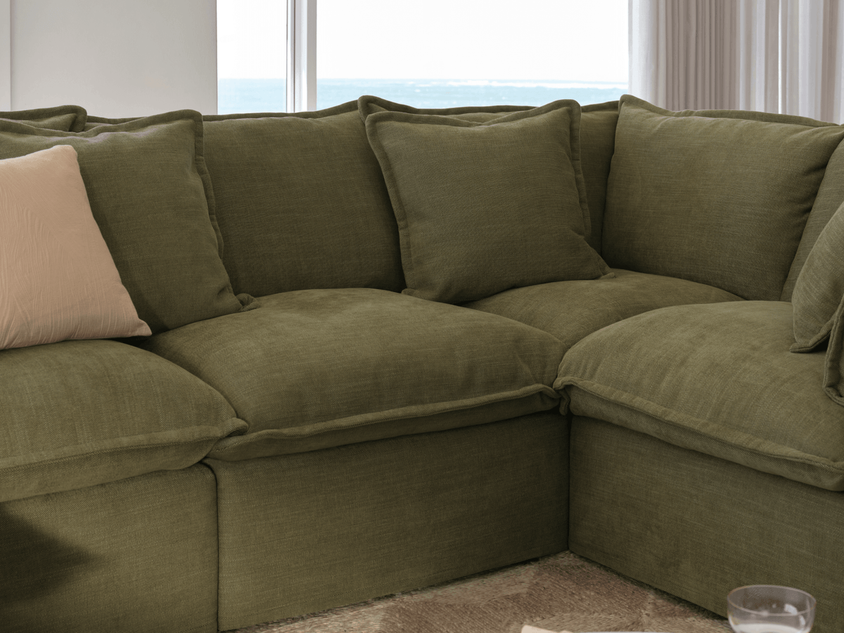 Koala Tamarama 6-section L-shape sectional in Forest Walk, with terracotta velvet cushion and city view