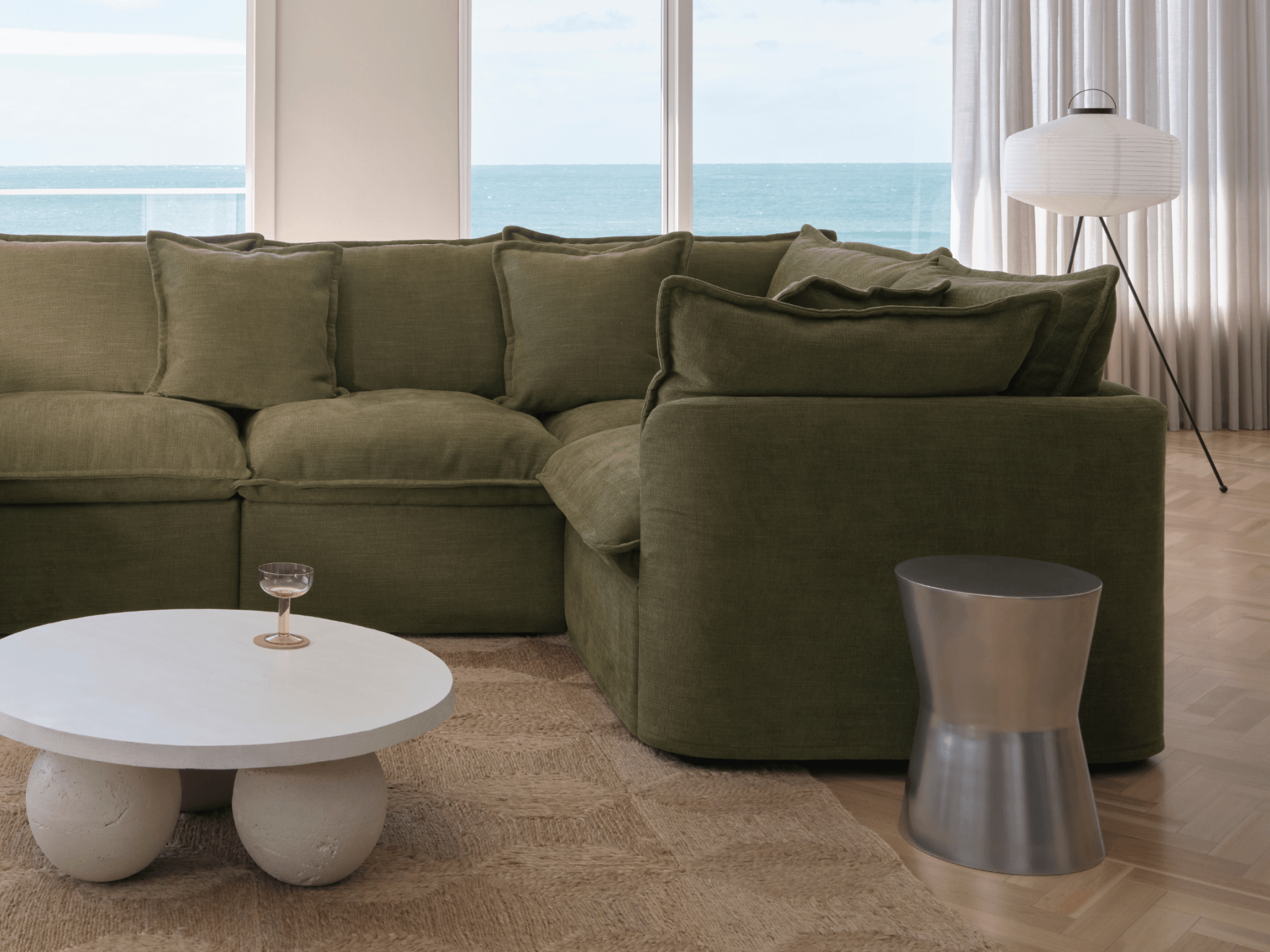 Koala Tamarama 6-section U-shape sectional in Forest Walk, linen scatter cushions with sunlit art books