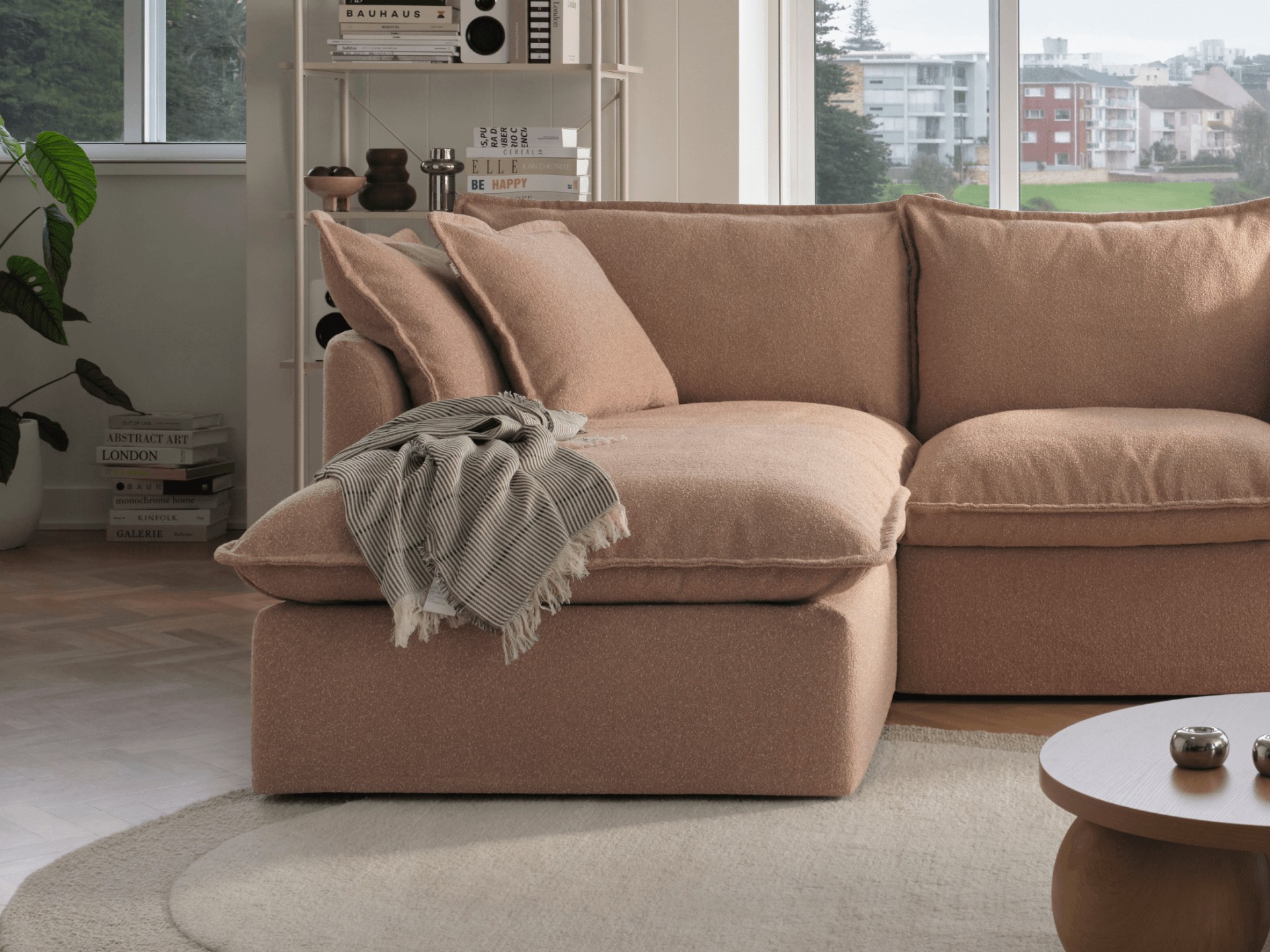 Koala Tamarama 2-section chaise modular sofa in Pebble Beach, with monstera plant and terracotta velvet cushion