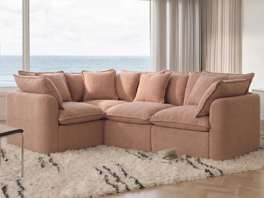 sectional sofa in a room with large windows and a view of water.