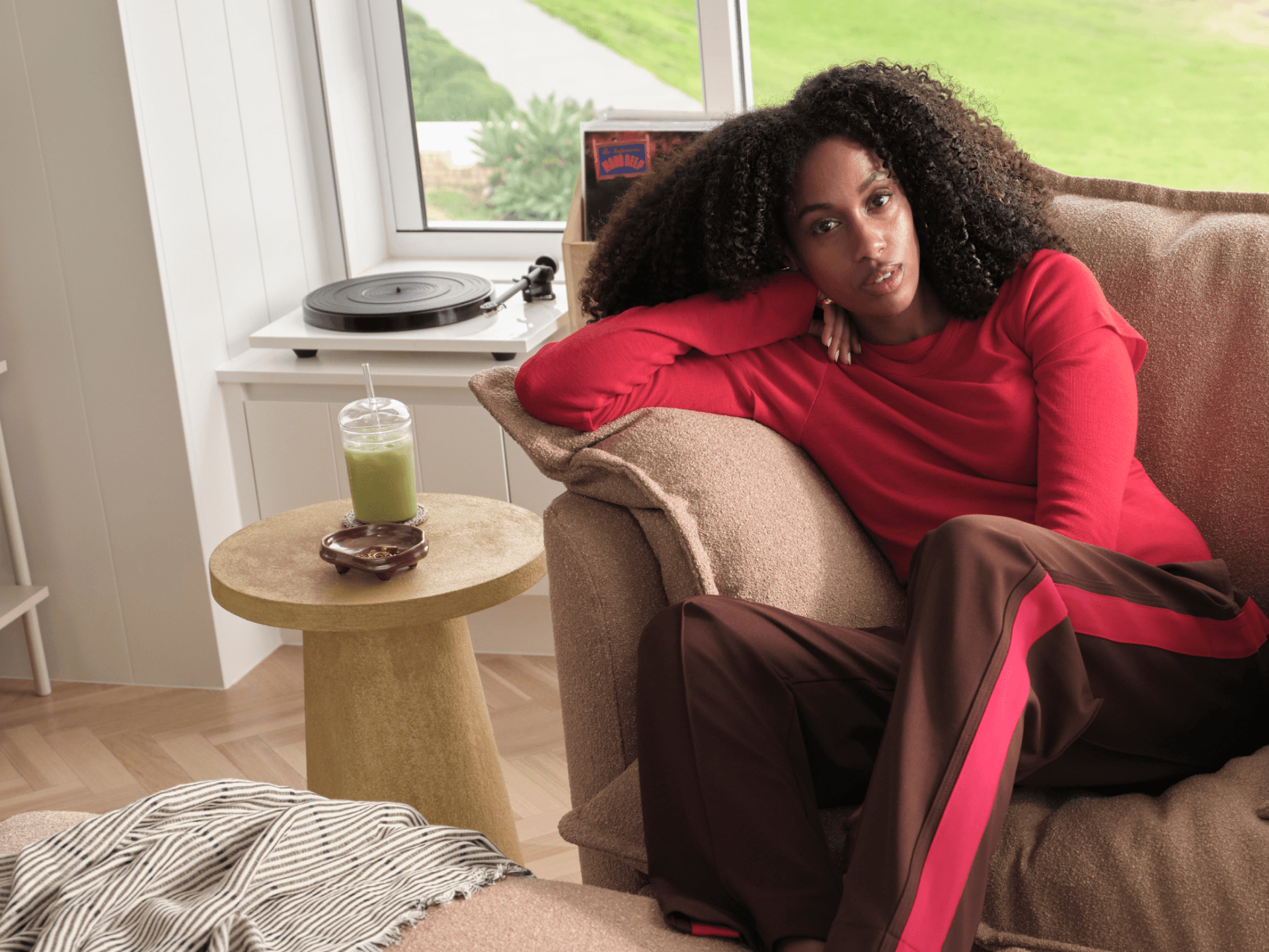 Koala Tamarama 5-section L-shape sectional in Pebble Beach, with terracotta velvet cushion and city view