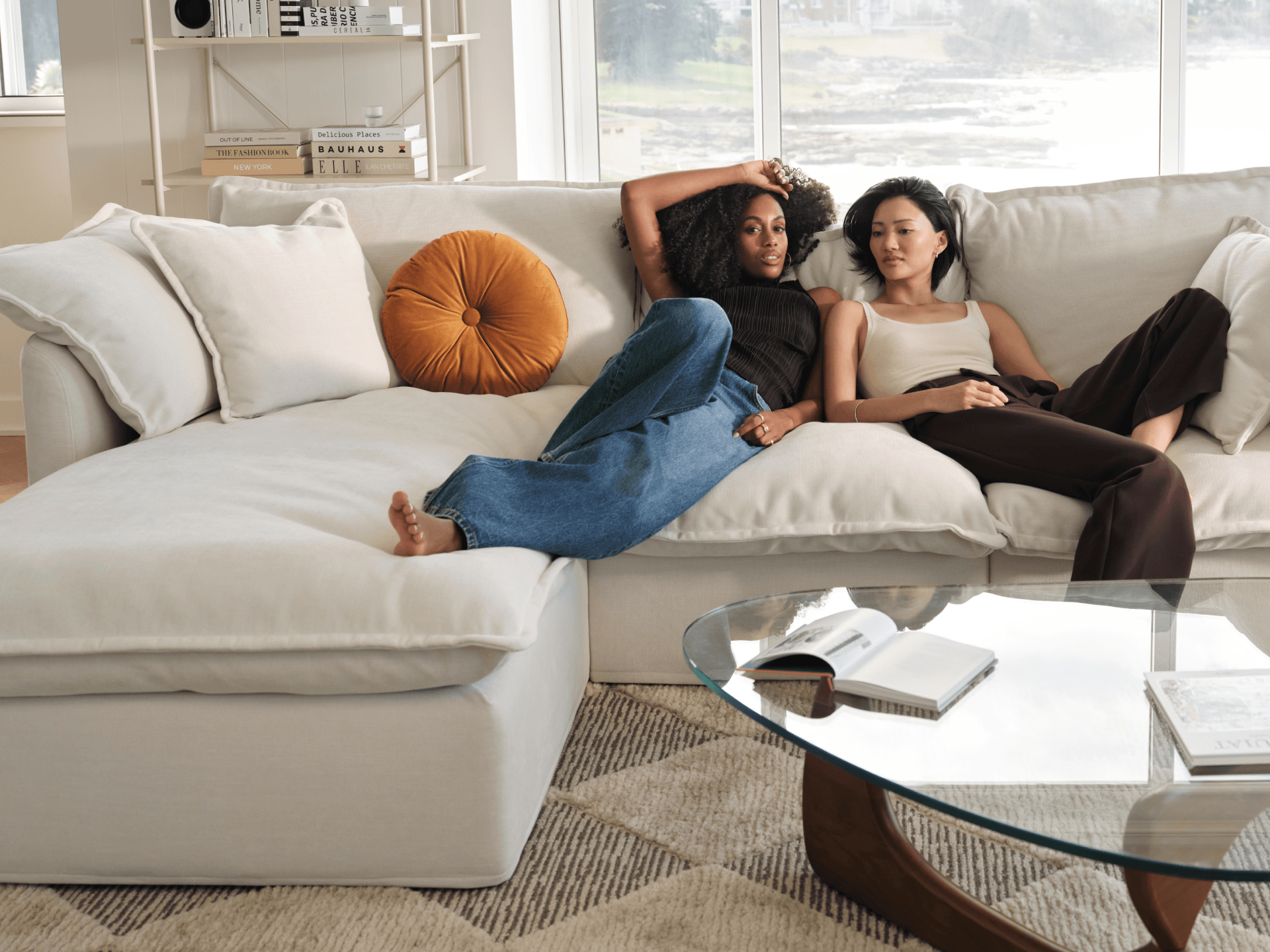 Koala Tamarama 4-section chaise modular sofa in Winter Cream, linen scatter cushions with sunlit art books