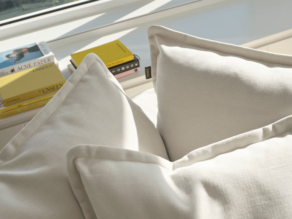 Koala Tamarama 5-section L-shape sectional in Winter Cream, linen scatter cushions with sunlit art books