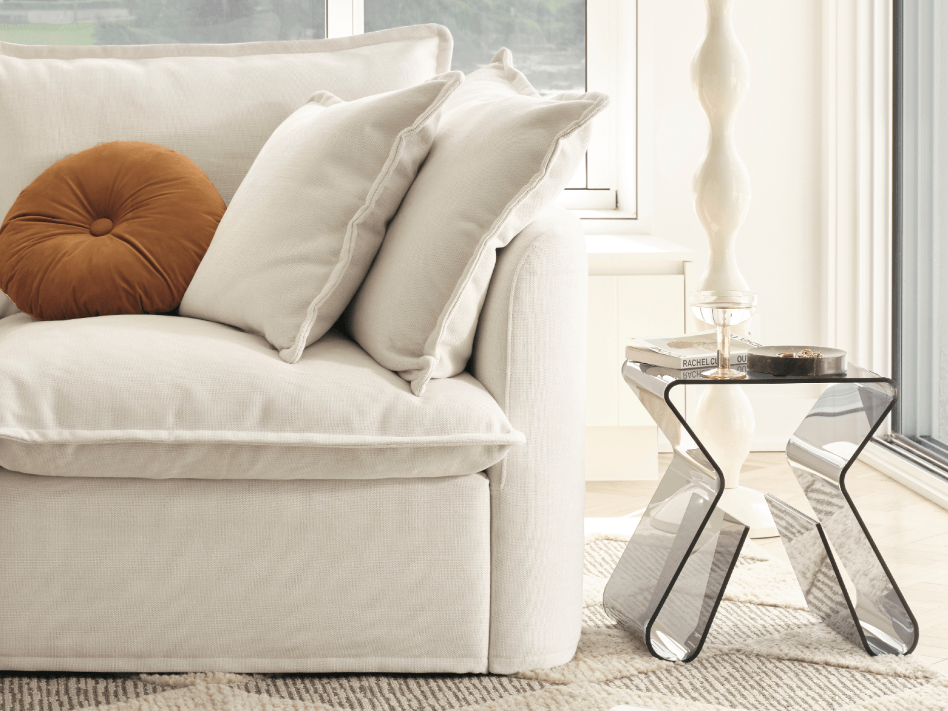 Koala Tamarama 6-section U-shape sectional in Winter Cream, corner detail with terracotta cushion and wavy lamp