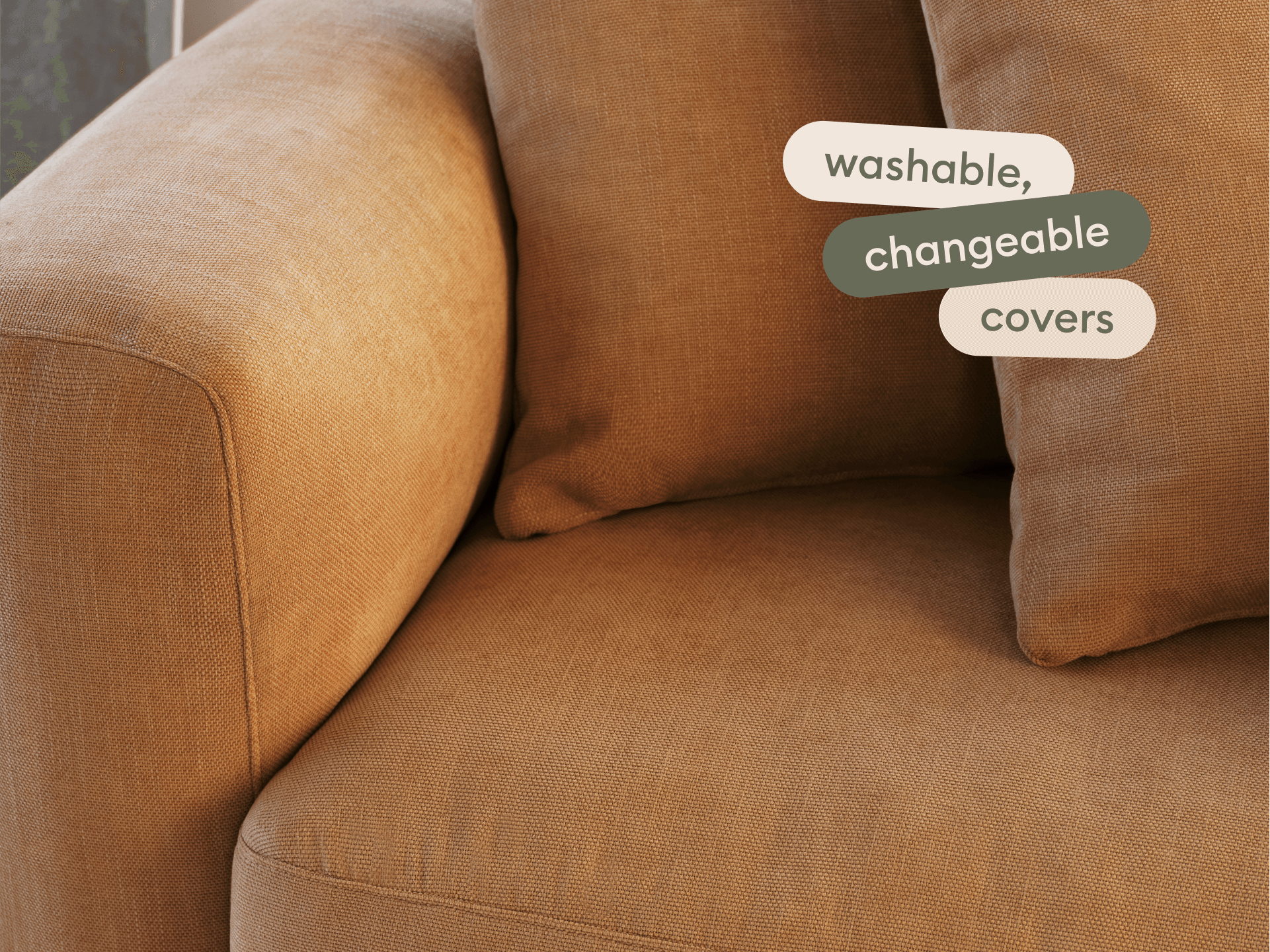 Modern armchair with plush, washable, changeable light brown fabric covers. Soft cushions, curved lines, ideal for luxury living spaces.