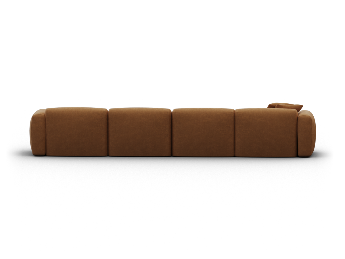 Luxurious modular sofa in rich caramel leather, featuring plush cushioning and seamless design, set in a contemporary living space.