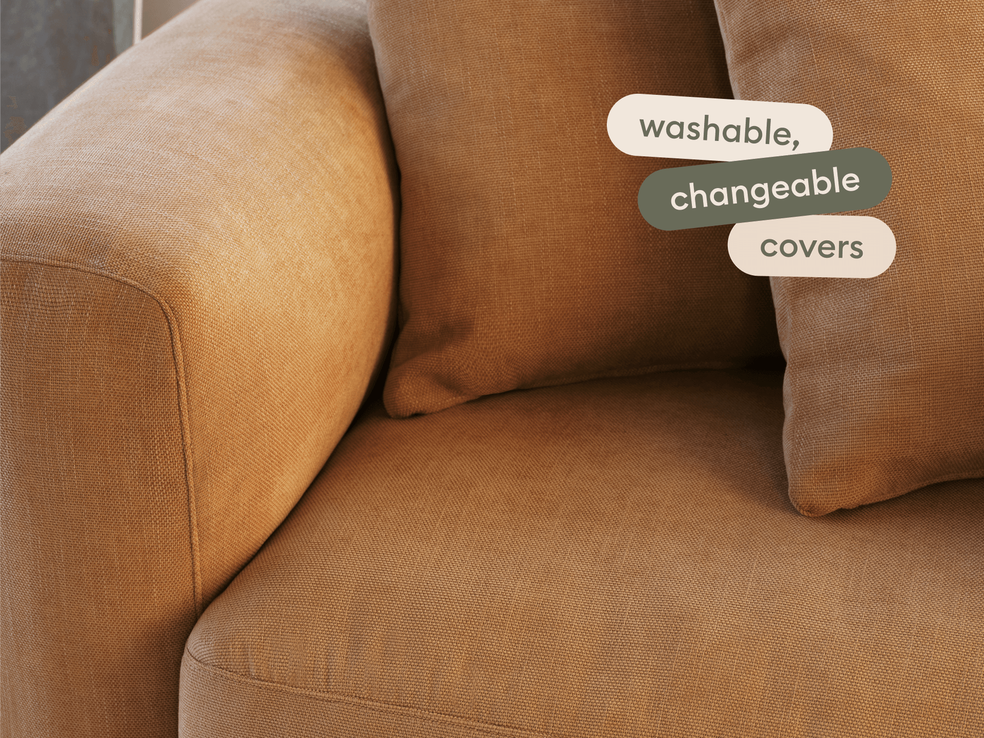 Elegant brown fabric sofa with plush cushions, featuring removable, washable covers. Smooth modern lines, perfect for a sophisticated living room ambiance.