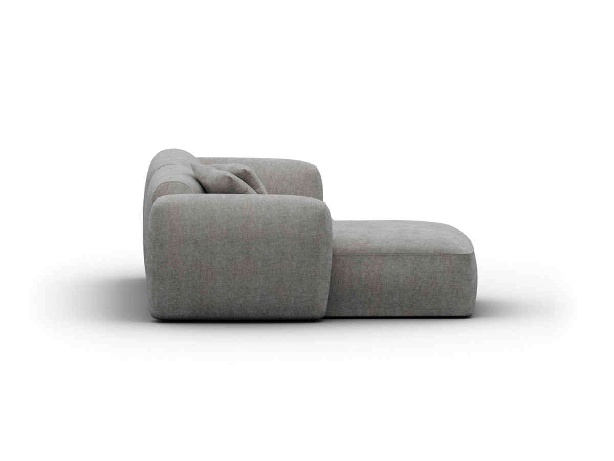 Modern grey upholstered sectional sofa, featuring textured fabric and plush cushioning. Minimalist design perfect for contemporary living spaces.