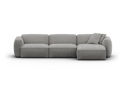 Elegant modular sofa in soft grey fabric, featuring a plush chaise lounge. Rounded arms and tailored cushions enhance modern luxe. Perfect for spacious interiors.