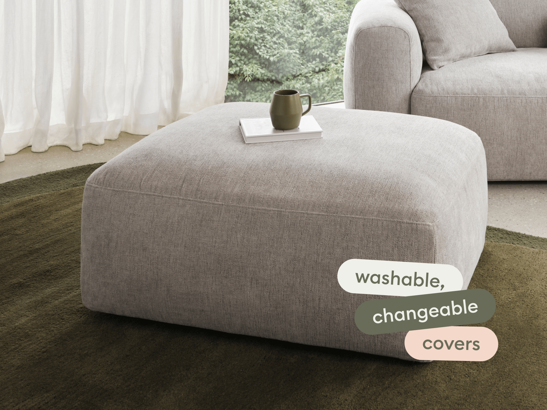Luxurious ottoman in beige linen with washable, changeable covers. Features a minimalist design, perfectly complementing the modern, plush sofa setting.
