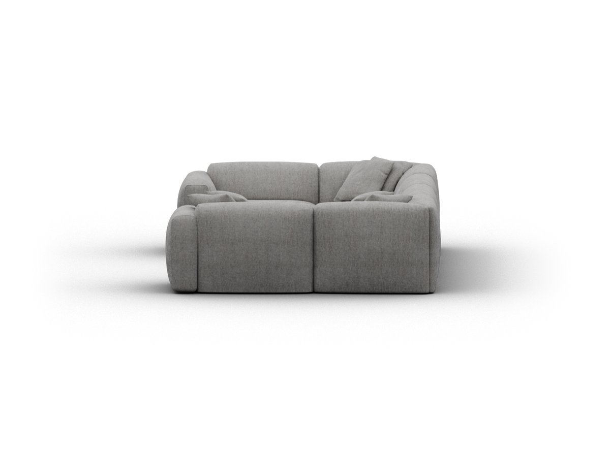 Luxurious grey fabric sectional sofa with plush cushions. Modern, curved silhouette perfect for upscale living spaces. Textured upholstery adds sophistication.