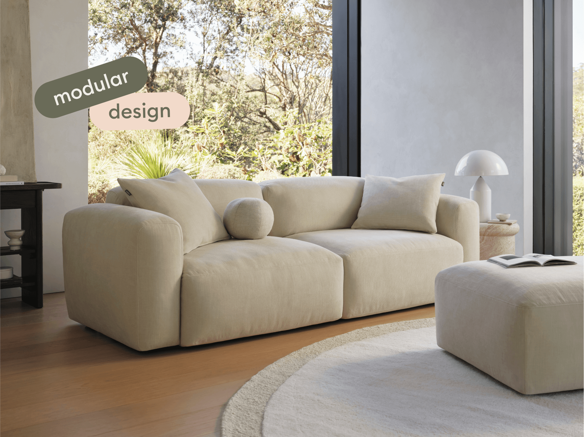 Torquay Modular Sofa with ottoman in modern living room with large windows