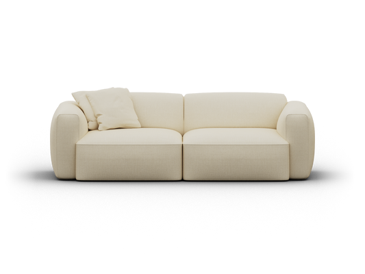 Cream-coloured modern sofa with plush cushions and soft upholstery, featuring curved armrests and a minimalist design, set against a neutral backdrop.