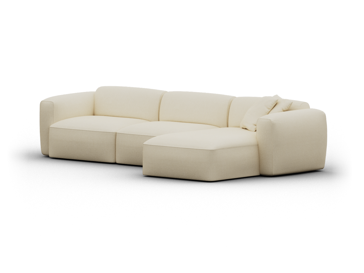 Luxurious cream modular sofa with plush fabric upholstery, rounded arms, and a chaise lounge. Perfect for spacious modern living rooms.