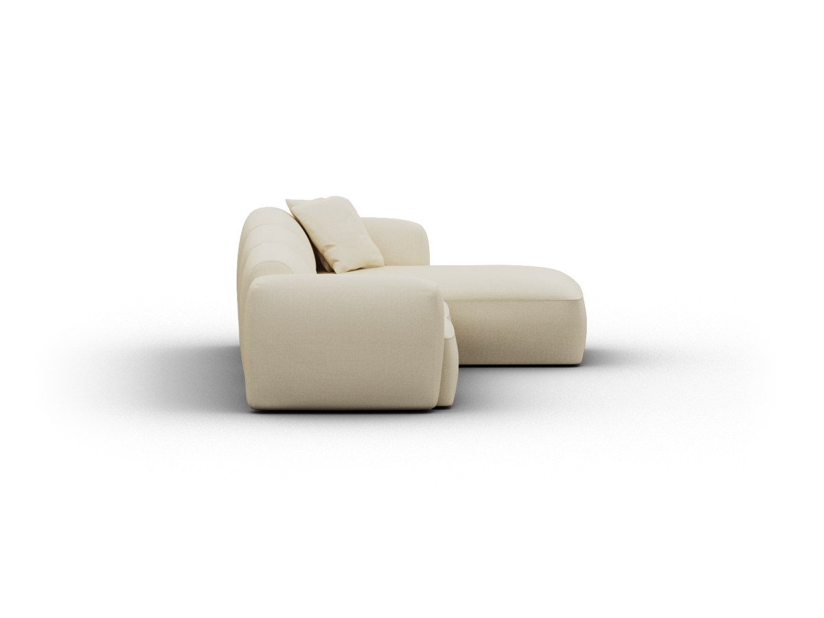 Luxurious beige fabric chaise lounge with plush cushions, featuring minimalist design and curved armrests. Perfect for sophisticated, modern living spaces.