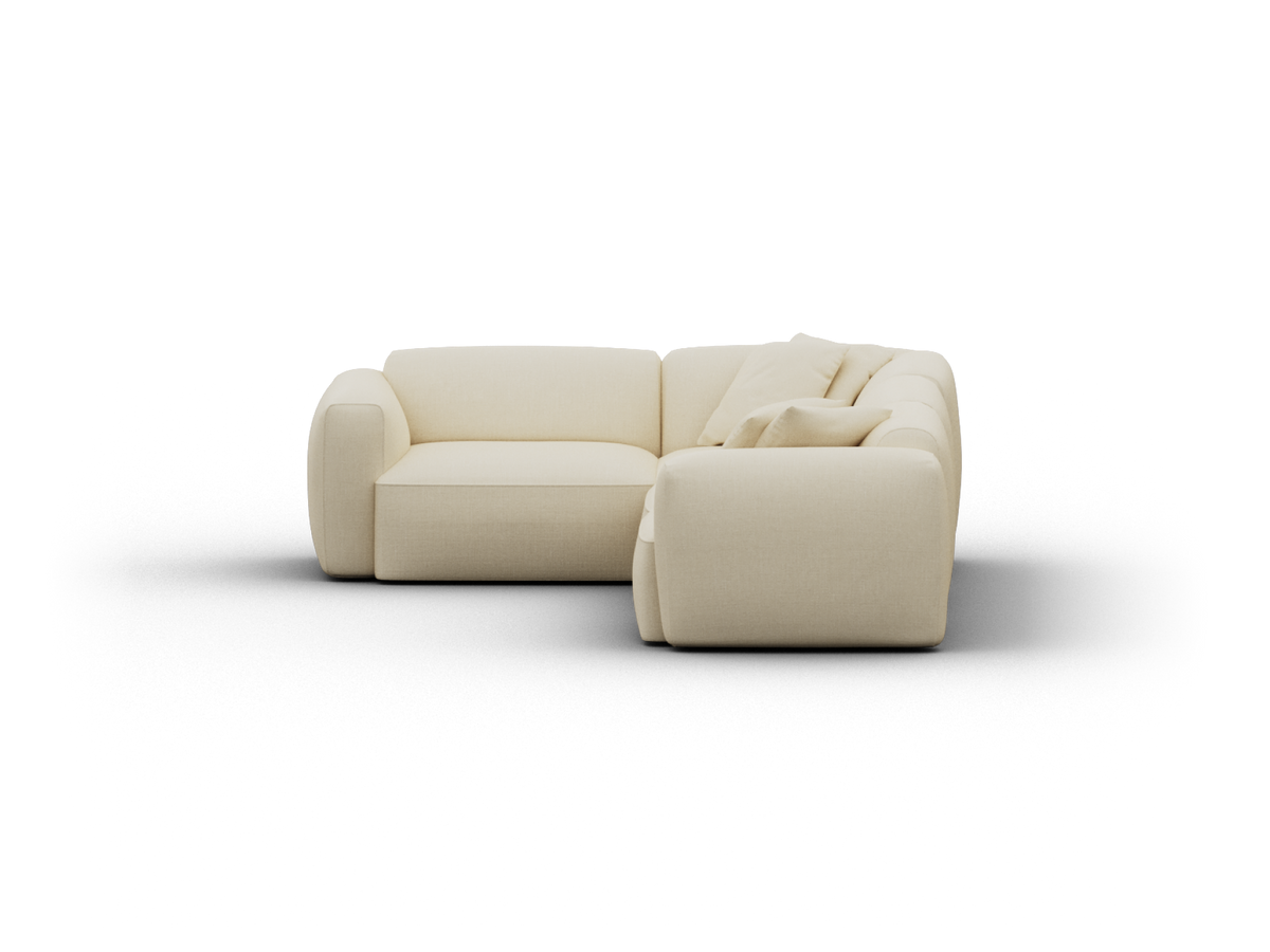 Luxurious cream L-shaped sectional sofa with plush upholstery, featuring rounded armrests and deep seats, ideal for a sophisticated living room setting.