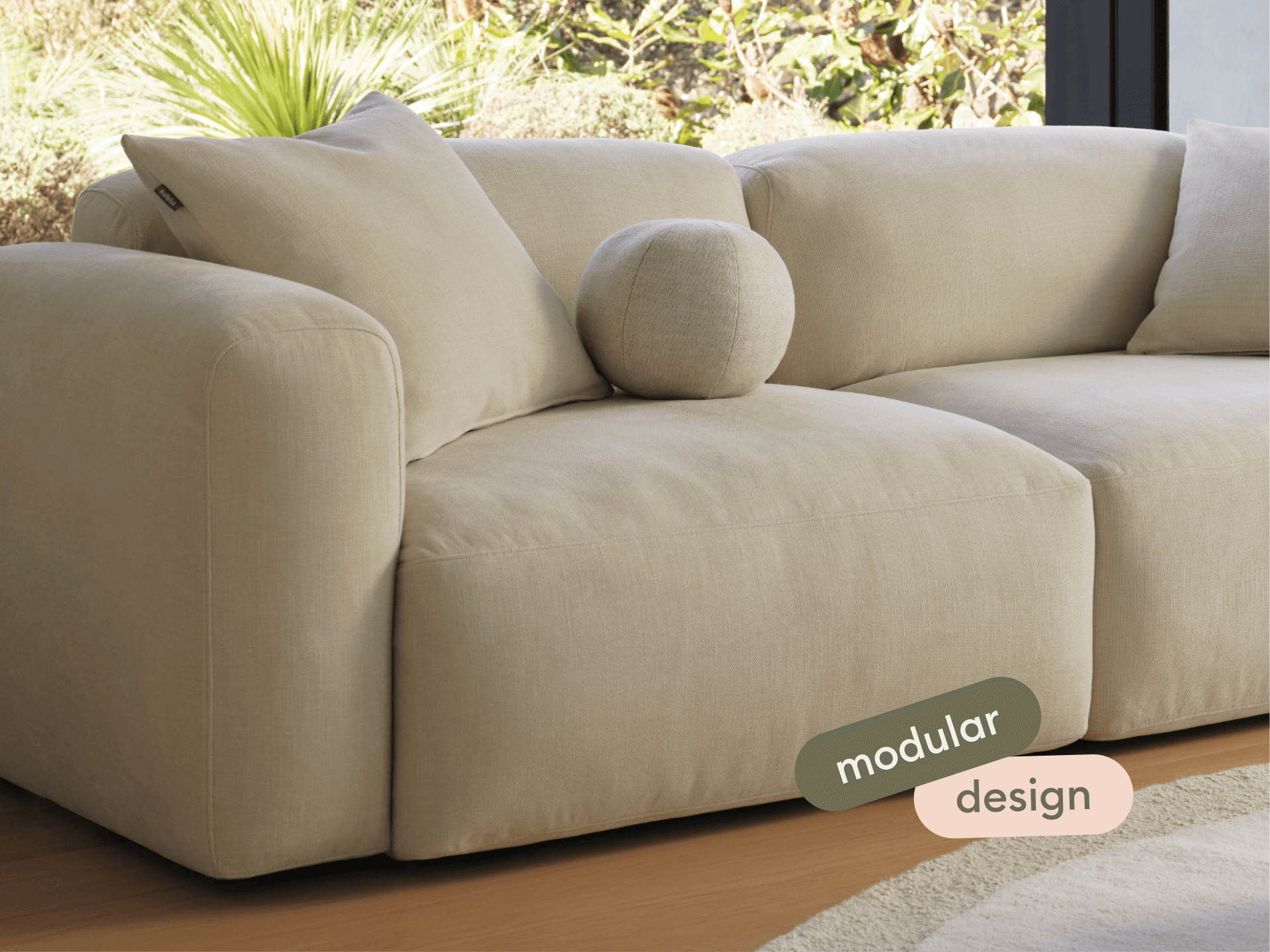 Luxurious beige modular sofa in soft fabric, featuring plush cushions and a minimalist design. Perfectly placed in a serene living room setting.