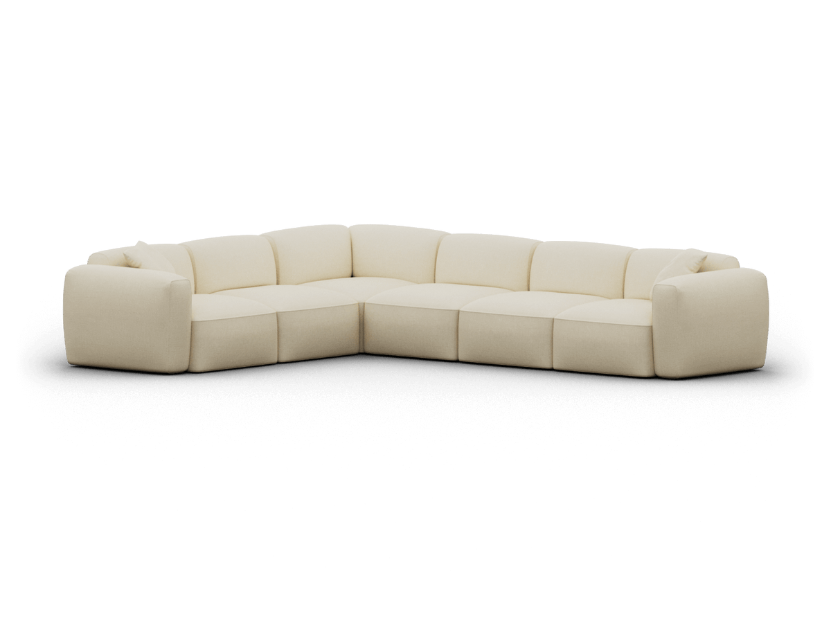 Cream fabric modular corner sofa with plush cushions and wide armrests, creating a cosy yet sophisticated lounge setting.