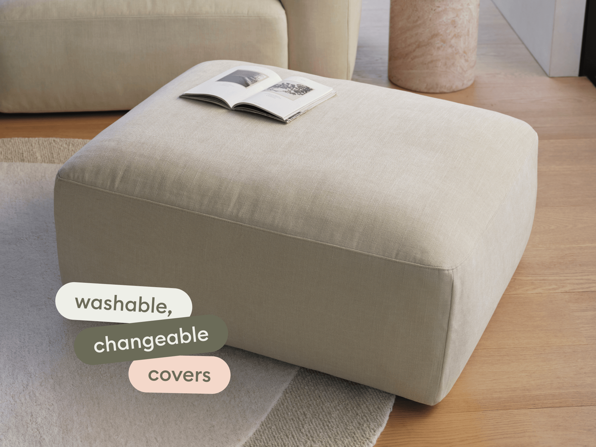 Beige linen ottoman with washable covers, rectangular shape, on wooden floor. Pairs with neutral decor and plush rug in elegant living space.