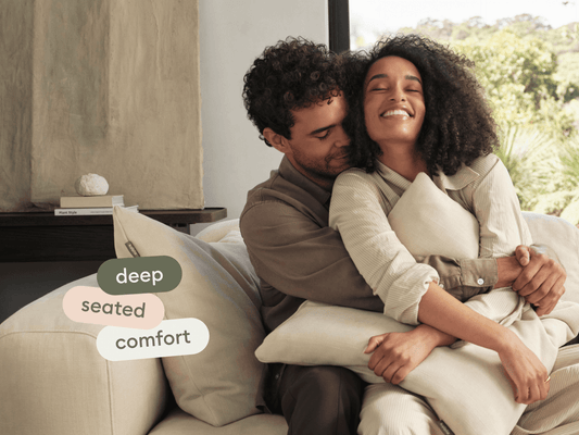 Luxurious beige sofa, featuring plush deep seating with soft cushions; crafted from premium fabric, ideal for a contemporary living room setting.