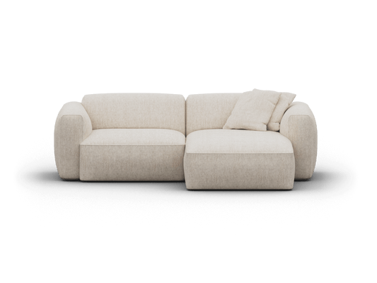 Luxurious beige fabric sofa with chaise, featuring a minimalist design and plush cushions. Perfect for a sophisticated living room setting.