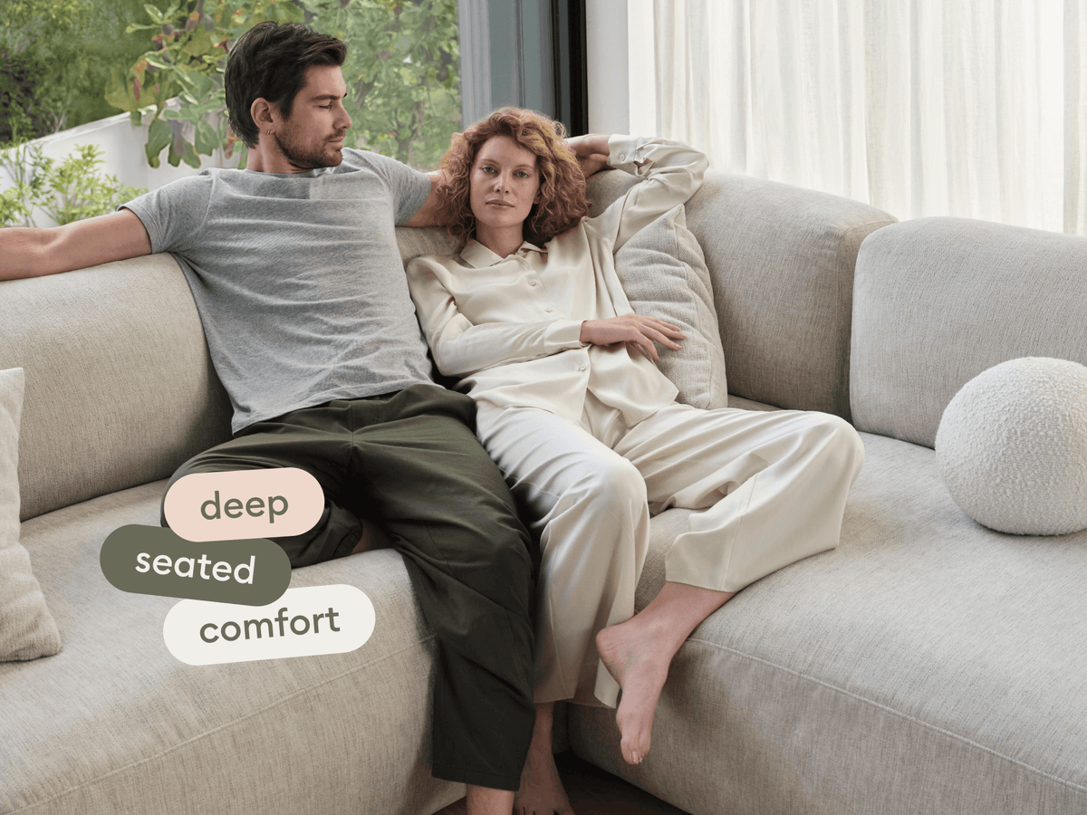 Luxurious beige sectional sofa featuring deep seating, plush upholstery, and modern design. Perfectly complements airy space with large windows and lush greenery.