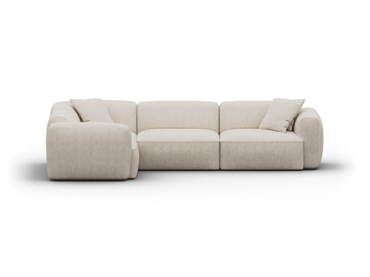 Luxurious modular sectional sofa in cream fabric with plush cushions. Features soft curves and boxy design, ideal for a sophisticated living room.