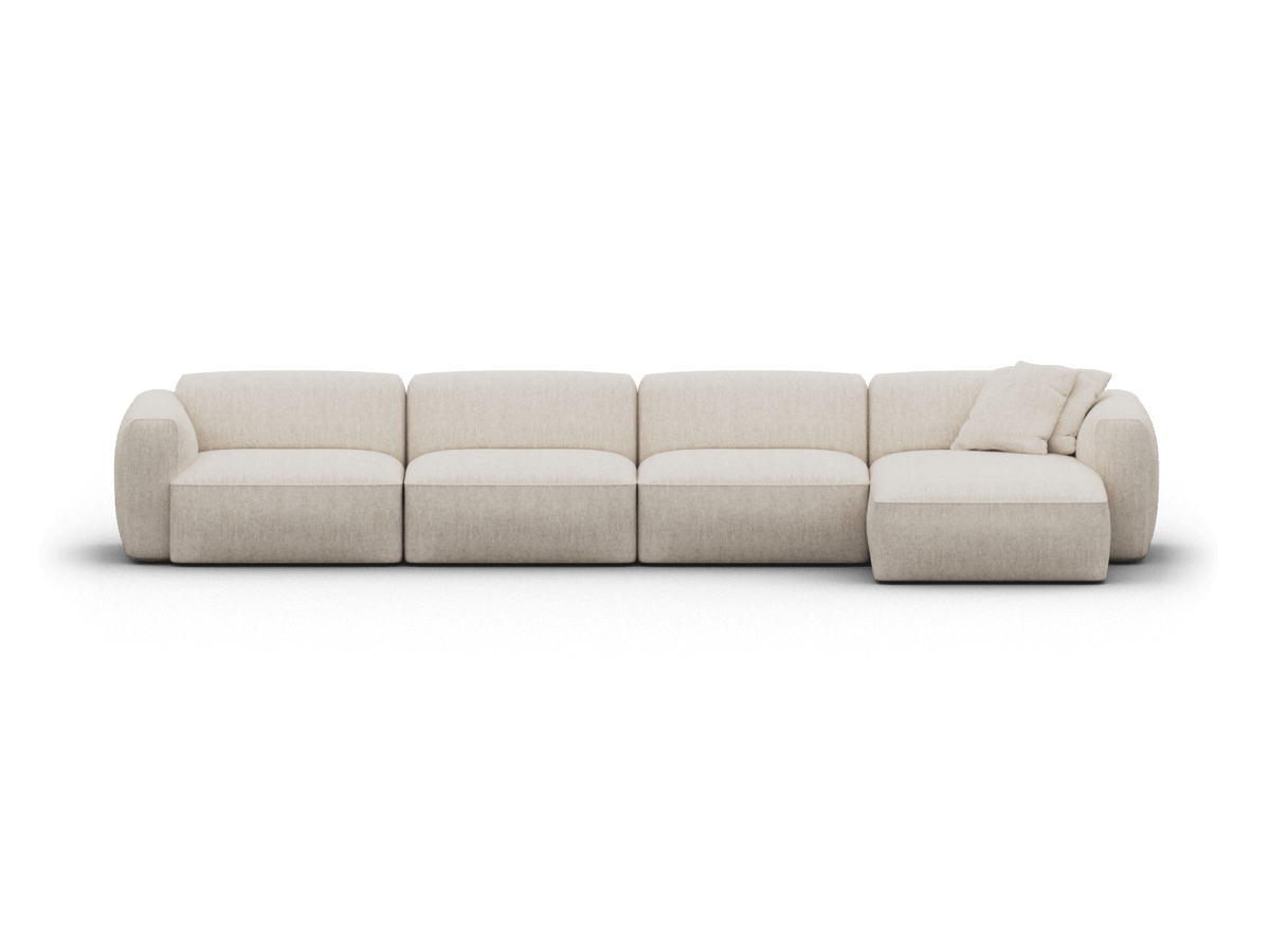 Luxurious modular sofa in textured cream fabric, featuring plush cushions and a chaise lounge. Set in a minimalist space, it embodies modern elegance.
