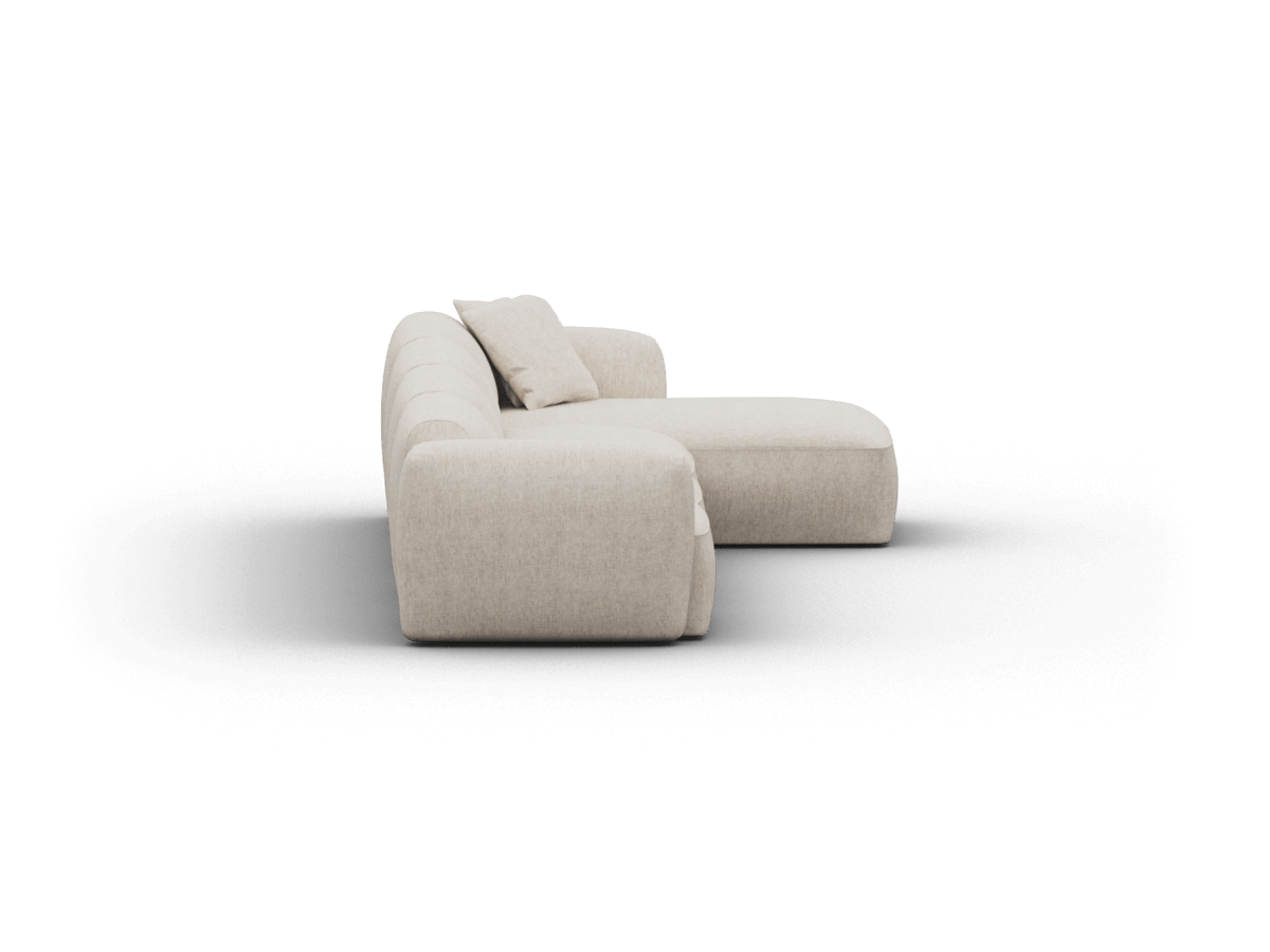Luxurious cream chaise lounge crafted from premium fabric. Features plush cushioning and rounded edges, ideal for sophisticated, contemporary living spaces.
