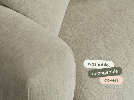 Luxurious beige fabric sofa with washable, changeable covers. Soft texture, inviting modern design, perfect for contemporary living spaces.