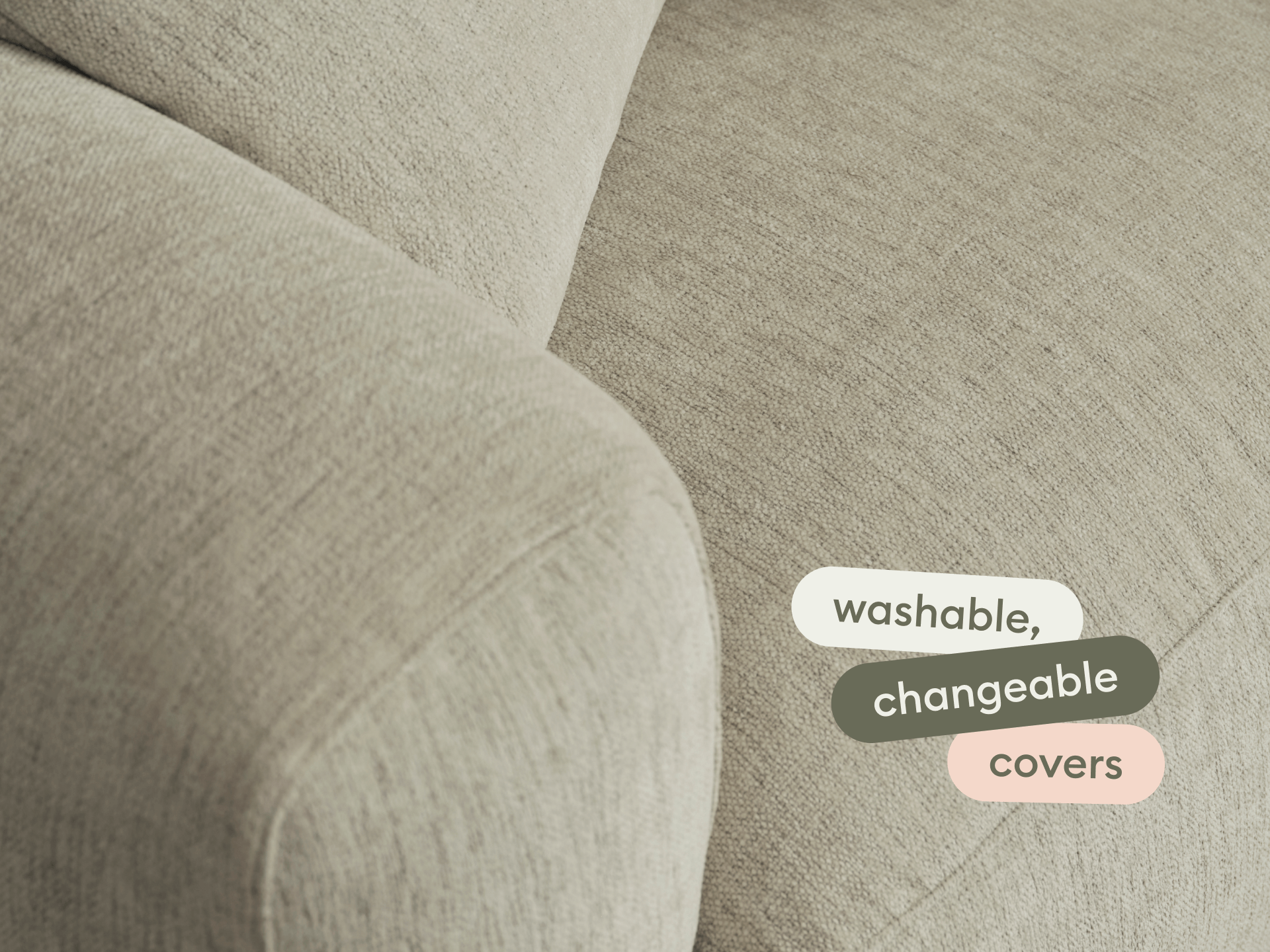 Modern beige fabric sofa with smooth, rounded armrest. Features washable, changeable covers. Ideal for a contemporary living room setting.