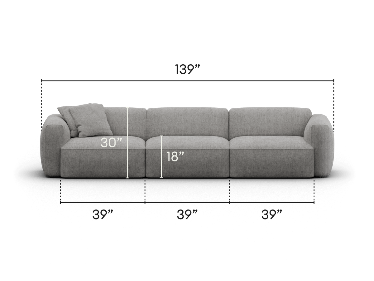 Elegant grey sectional sofa with plush fabric upholstery and rounded armrests. Features wide seating and modular design, perfect for modern living spaces.