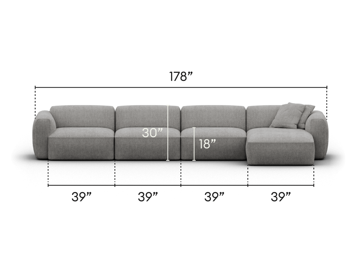 Luxurious sectional sofa in soft grey fabric, featuring plush cushions and a chaise end. Sleek design with modular sections, perfect for modern living spaces.