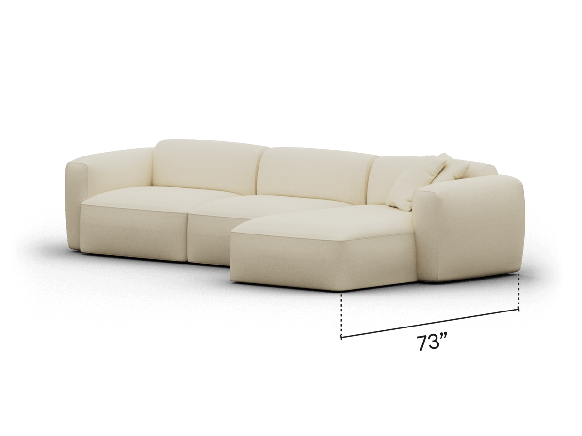 Cream-coloured modular sectional sofa in plush upholstery, featuring a left-facing chaise lounge. Modern design in a sophisticated living room setting.