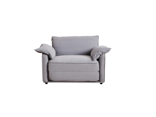 A light grey, modern armchair with soft, plump cushions and rounded edges, featuring two matching throw pillows on either side.