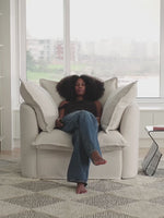 person lounging on comfy white sofa in bright living room