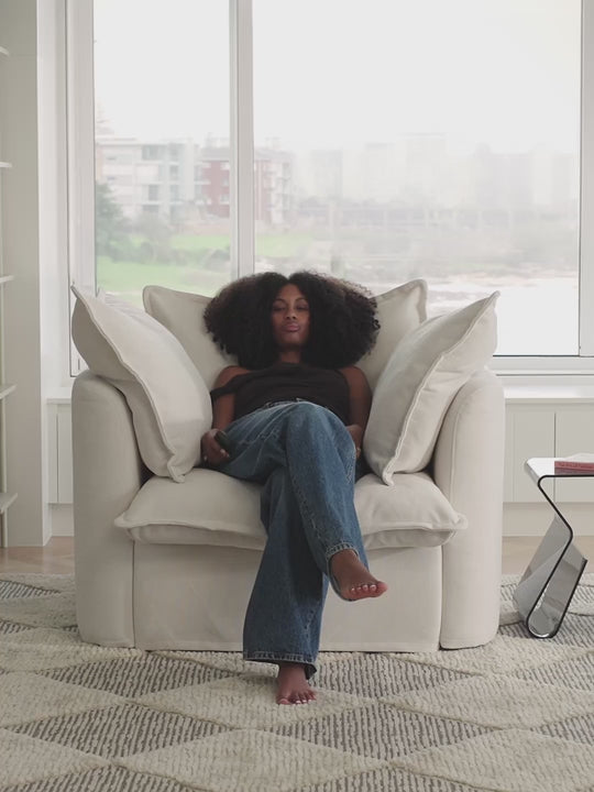 person lounging on comfy white sofa in bright living room