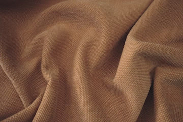 details of the brown fabric close up with a woman spilling water and easily cleaning it up